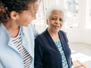 Nurse speaking to elderly patient.