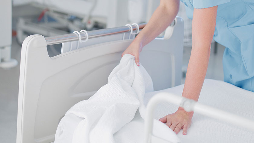 Clinician changing sheet on mattress
