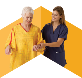 Attendant in blue scrubs helping a patient in a yellow gown to walk.