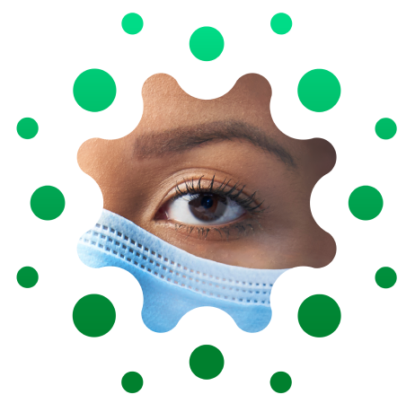 SYM_IP emblem_RGB 1 (1) Close-up of female caregiver's eye and top edge of a face mask, cropped in distinctive circular shape