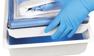 OTH_lifting trays_WEB_RGB 2 Gloved clinician's hands lifting out the top tray of a central line insertion bundle