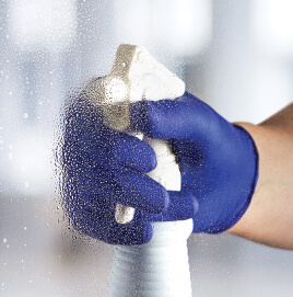 PAP_EVSCHEM201_Cover EVS worker's gloved hand spraying disinfectant on a surface