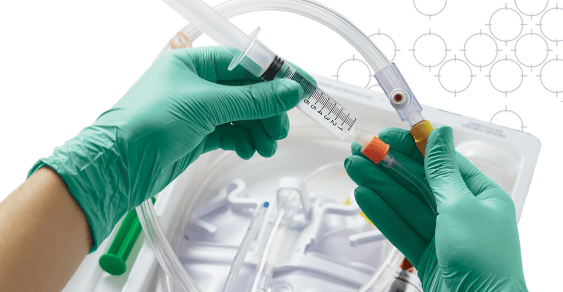 Gloved clinician’s hands removing indwelling urinary catheter from tray over patterned background Gloved clinician's hands removing indwelling urinary catheter from tray over patterned background