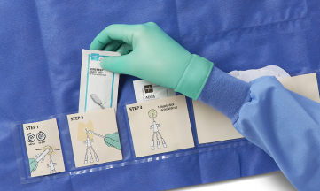 SKU_EBSI1254_With Hand_018_RGB_02 2 Gloved hand picking up a packaged alcohol swab from a pocket in a dressing change system for a central line