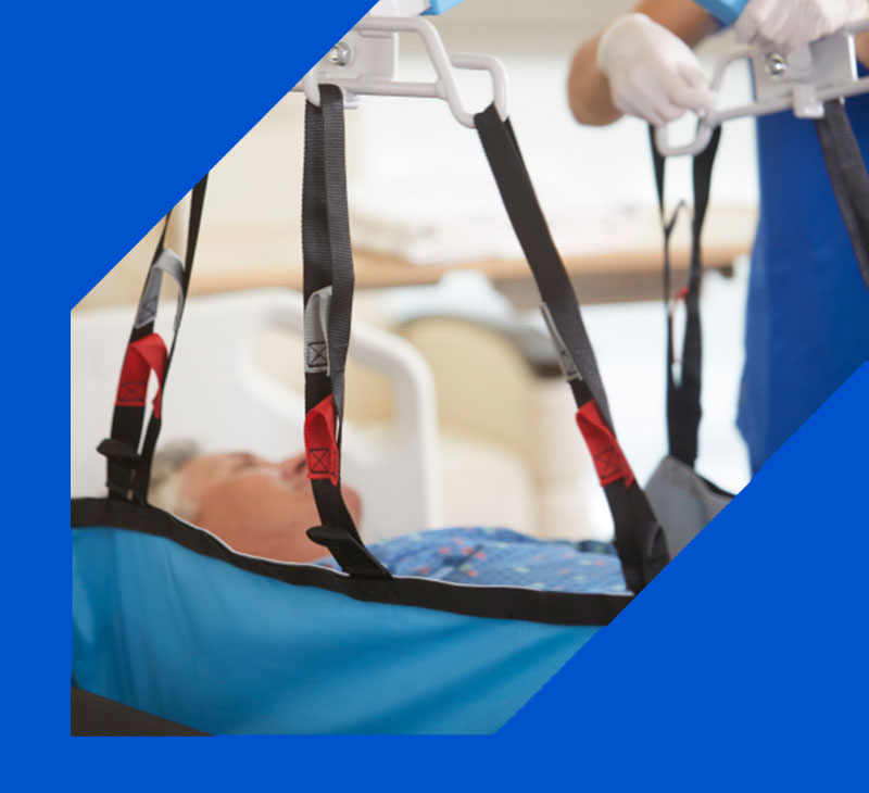 Caregiver using a sling and lift to transfer a patient