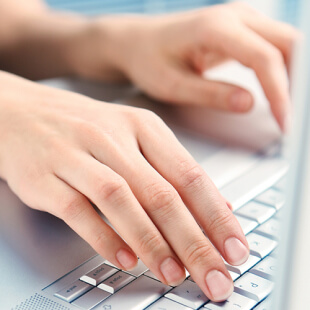 hands-laptop Hands typing on a keyboard