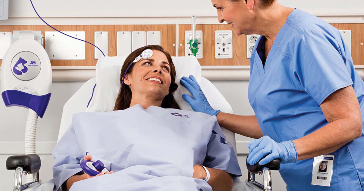 Monotone blue image of a caregiver reassuring a patient before surgery