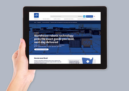 STK-iPad-Warehouse-robot Hand holding up a tablet with an image of another case study or online content related to Medline's strategic approach