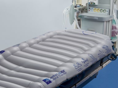Close up of ComfortGlide Lateral Transfer Sheet in a room with other medical equipment