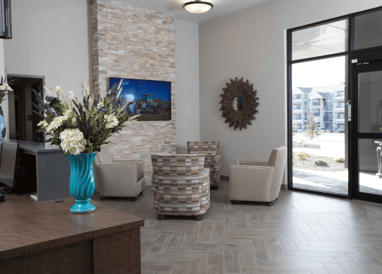 A lobby with four chairs