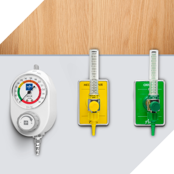 A white suction regulator next to a yellow and a green oxygen flowmeter