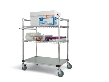 Disposable surgical supplies in a Complete Delivery System corrugated container on top shelf of case cart