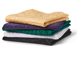 Stack of cloth tablecloths in a variety of colors