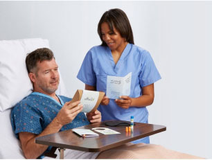 Female caregiver showing male patient what is in his personal care kit