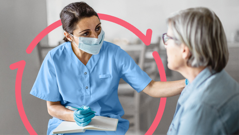 A female nurse with a pad and pen in her lap speaks to a woman