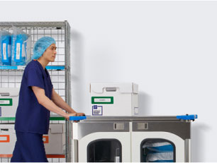 Male clinician pushing surgical case cart