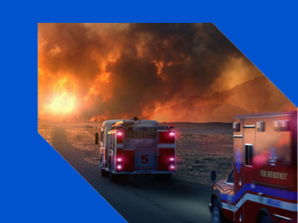 Firetrucks racing down the highway toward a wildfire
