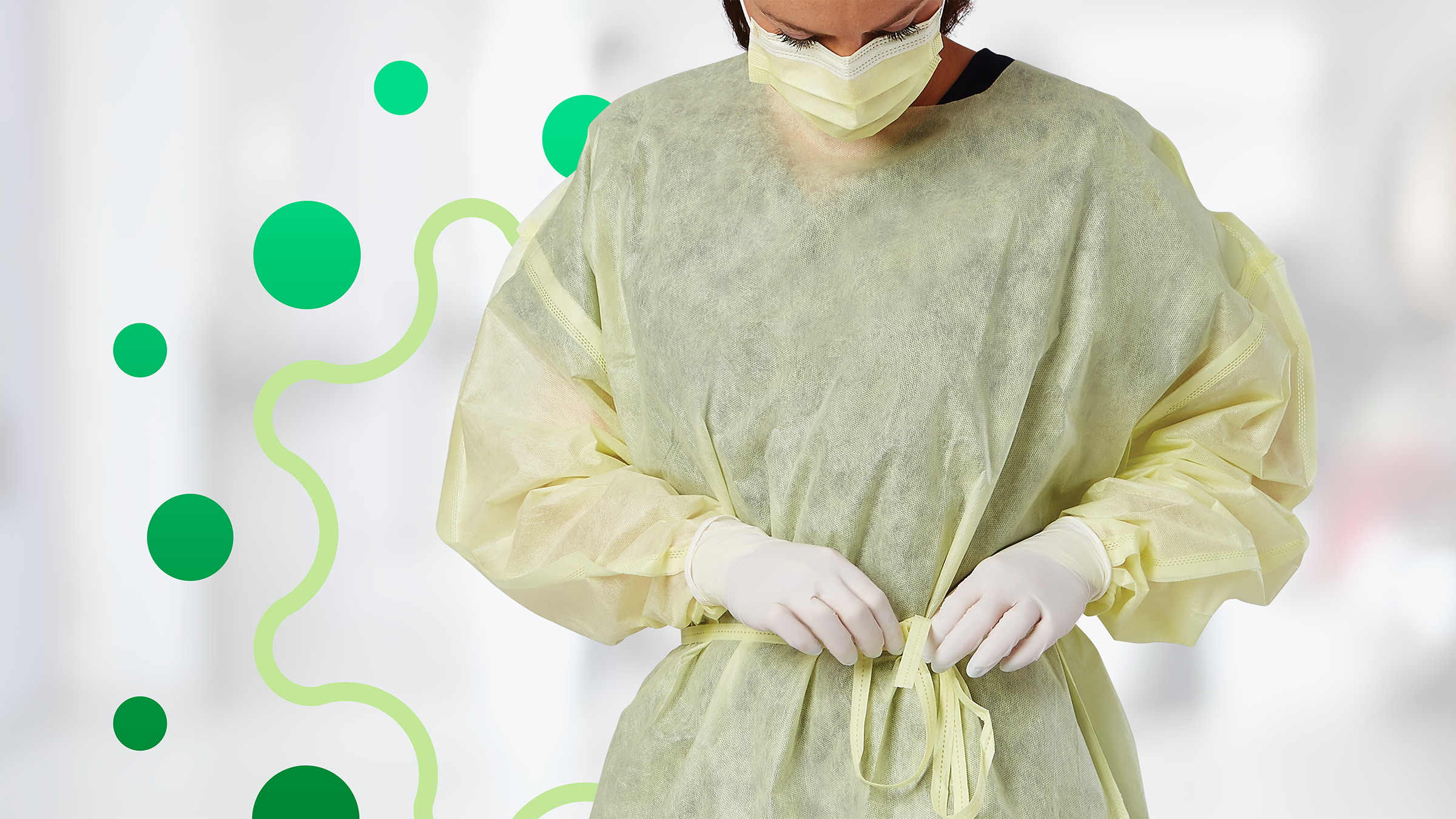GRP_NONLV240_gown article_02_RGB Healthcare worker securing a Level 1 gown