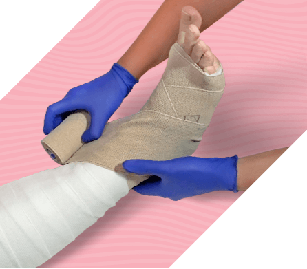 Gloved hands wrapping leg with compression system