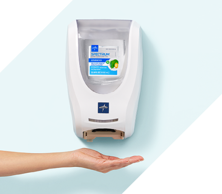 Wall mounted touchless Spectrum dispenser with hand under it to activate sensor;.