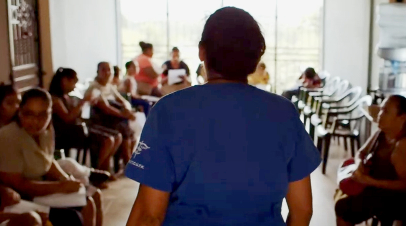 image of a healthcare worker facing a full waiting room