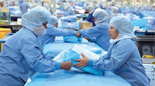 two warehouse workers packing medical products