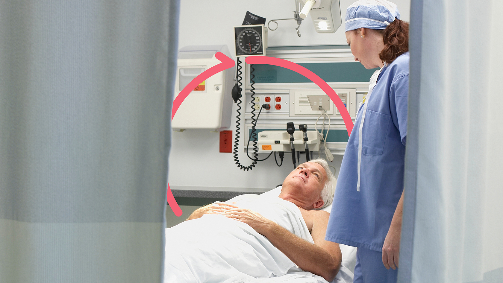 Clinician talking to patient lying on emergency department mattress