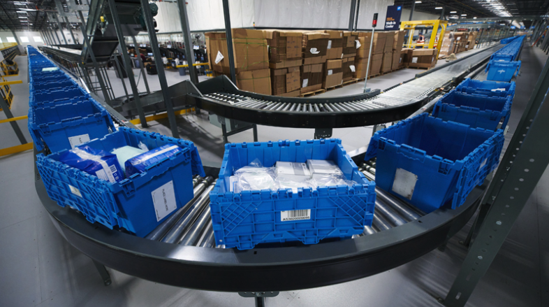 blue bins with medical supplies on a conveyor belt