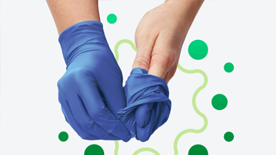 Healthcare worker removing exam gloves
