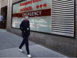 nurse-walking-outside-hospital-in-NYC nurse walking outside hospital in NYC
