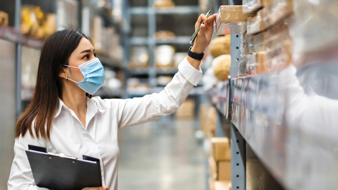 image of a woman pulling product off the shelf