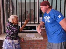 photo of caregiver talking to patient in the Dominican Republic