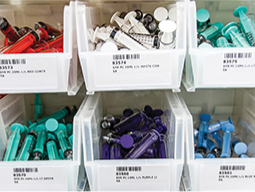 photo of white bins with color coded supplies