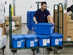 customized-sol-4-min person getting blue put-away-ready bins off of a u-boat