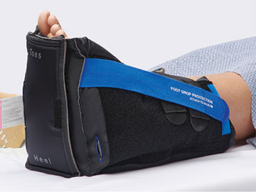 Patient wearing HeelMedix FootCheck Heel Protector with inspection panel for better wound care 