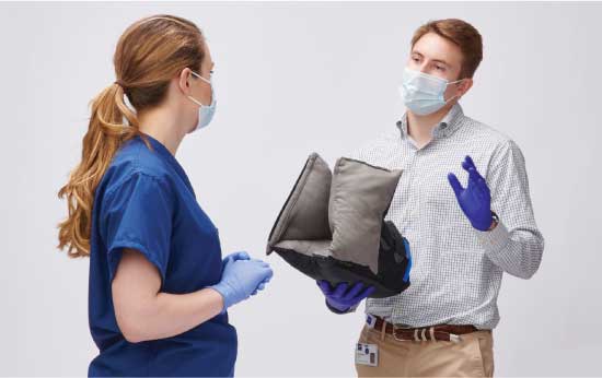 heelmedix-form-left-img Medline Skin Health Representative demonstrating heel protector boot’s features for a caregiver