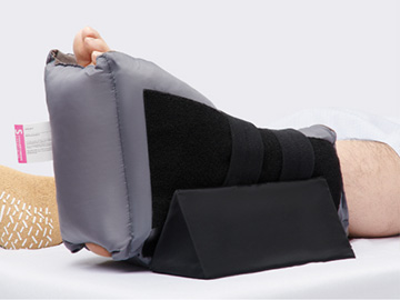 heelmedix-pro-new Patient wearing HeelMedix Pro Heel Protector with anti rotation wedge on heel, which reduces pressure