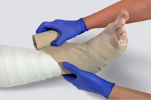 HeelMedix Advanced Heel Protector with instructional toe/heel printing applied to patient’s heel in hospital bed
