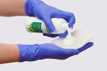 Caregiver’s gloved hands opening up boot to show its lining