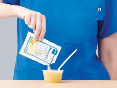 Clinician mixes specialized nutrition product for bowel regularity into applesauce