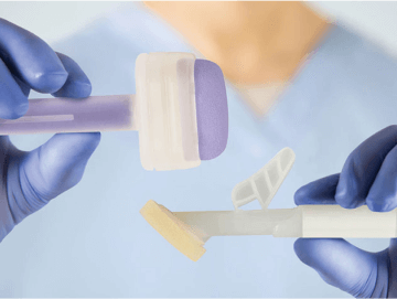 Caregiver holding up two different appilcators for liquid skin protectants