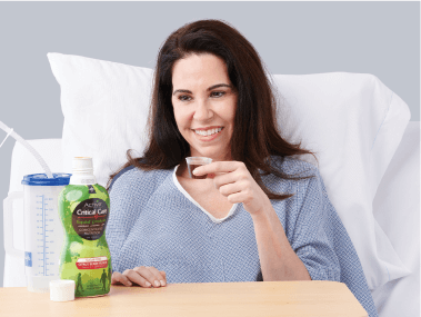Patient in hospital setting drinking clinical nutrition product for post surgical recovery