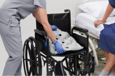 Meta Gloved caregiver hands dispense ISP antifungal powder to patient’s foot.