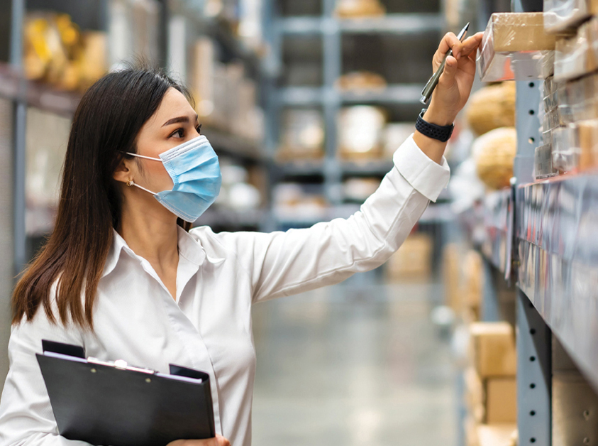alt tag= person verifying inventory on hand in a supply room or warehouse