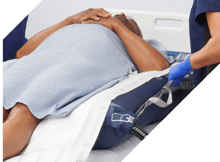 Clinician’s gloved hand applies Marathon XL to patient’s skin with wide applicator