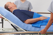 Caregiver’s gloved hands opening up boot to show its lining