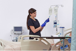 Nurse at a patient's bedside