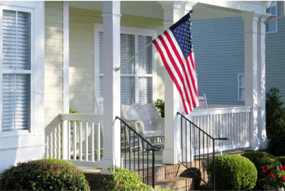  front porch of house with a US flag