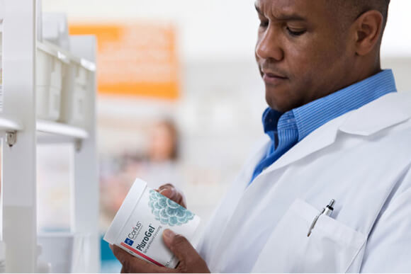 Clinician examines jar of PluroGel 