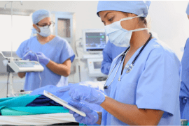 innovation-stratergies-1-min Healthcare workers in an operating room, preparing for surgery